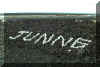 Junne's name spelled out in lava rock on the side of the highway